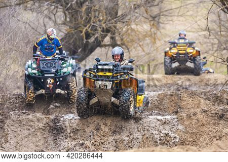 Afipsip, Russia - October 31, 2020: Sportsmen On Quad Bikes Drive Splashing In Dirt And Water At Mud