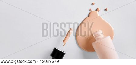 Banner With Mockup Glass Bottle Of Correction Cosmetic Product With Pipette. Spilled Liquid Foundati