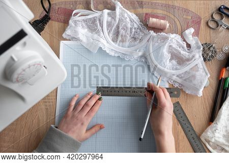 Top View Of Female Hands Are Drawing Design Of A New Collection Of Lingerie. Workplace Of A Professi