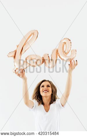 Woman holding a love foil balloon