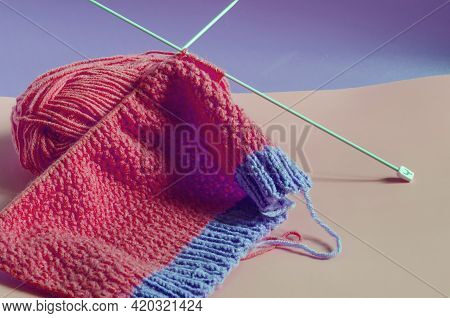 Knitting Accessories Skeins Of Yarn Knitting Needles And Knitted Blanks On A Pink Background Needlew