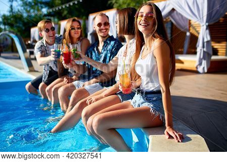 Pretty Woman Relax With Fresh Colorful Cocktail Glass Sitting By Swimming Pool On Sunny Summer Day W