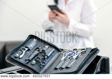A Set Of Hairdresser Scissors, Combs, Razor