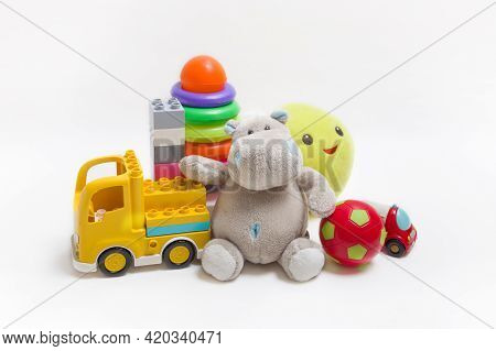 Group Of Childrens Toys On A White Background. Constructor, Pyramid, Ball And Soft Toys For Children