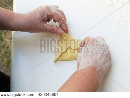 Women's Hands Blind The Edges Of The Samus With Meat Filling. Cooking In A Tandoor.