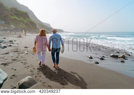 Lifestyle With Caucasian Senior Couple Walking On Beach, Happy In Love Romantic And Relax Time, Tour