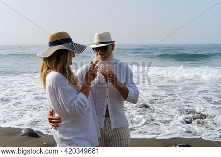 Lifestyle Of Caucasian Senior Couple Drinking Champagne On Beach, Happy In Love Romantic And Relax T