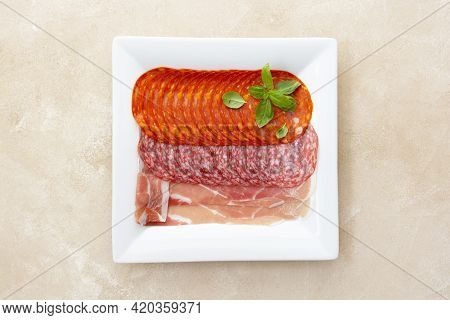 Different Meat Assortment Salami Slices In Plate.