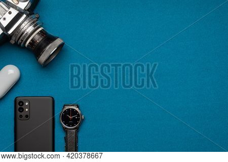 Flat-lay Of A Photographer's Tools - Camera, Mobile Phone, Wireless Earphones And A Good Watch