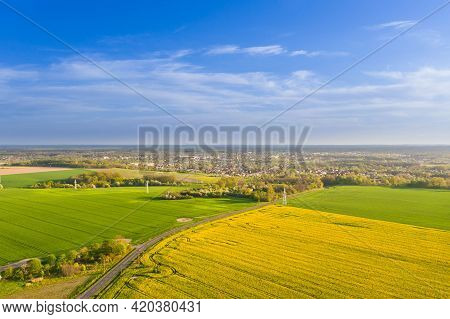Spring In Arable Fields. Yellow-blooming Rapeseed.\na Vast Plain Covered With Arable Fields, In Plac