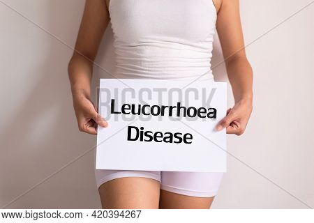 Woman Hands Holding A White Sign With The Word Leucorrhoea Disease On White Background