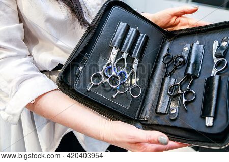 A Set Of Hairdresser Scissors, Combs, Razor