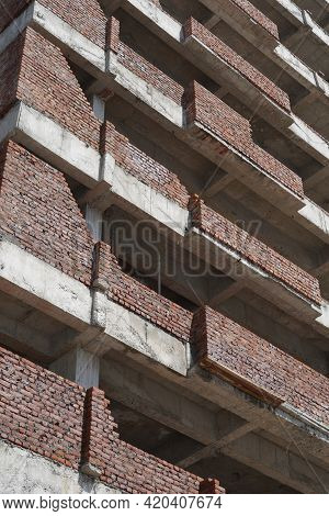 Building Under Construction Against Blue Sky. General View Of The Construction Of A New Residential 