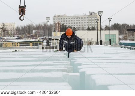 An Assembly Worker Tries To Crawl Through Ice Slabs