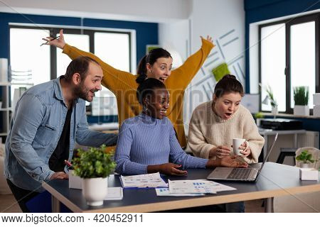 Diverse Startup Coworkers Entrepreneurs Celebrating Triump With Hands Up Lin Modern Office. Multieth