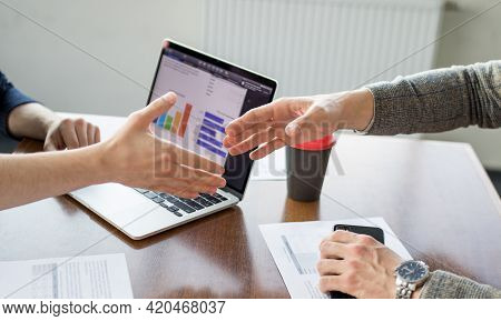 Close Up Of Young Businessman And Businesswoman Making The Fist Bump On Building Background. Busines