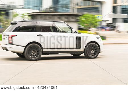 White Range Rover L405 Car Moving On The Street On High Speed. Fast Moving Luxury Suv Car On The Hig