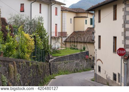 A Street In The Medieval Town Of Barga. Old Houses In A Thousand-year-old City. Spring In An Italian