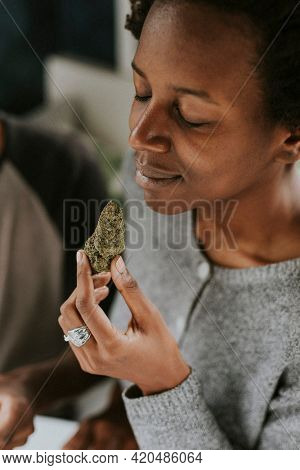 Woman holding weed in hand