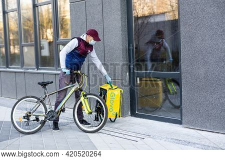 Kiev, Ukraine - April 28, 2021: Glovo Bike Courier On The Street. Delivery Boy Of Glovo Delivery Ser