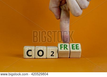 Co2 Free Symbol. Businessman Turns Cubes, Changes Concept Words 'co2' To 'co2 Free'. Beautiful Orang