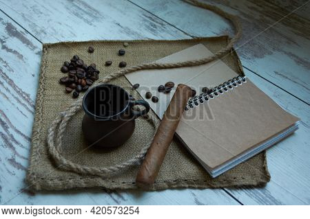 Coffee Cup, Coffee Beans, Cigar, Notepad, Brown Napkin Isolated On Wood Background