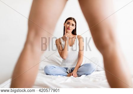Disappointed Woman Looking At Whats Between Mans Legs In Bedroom
