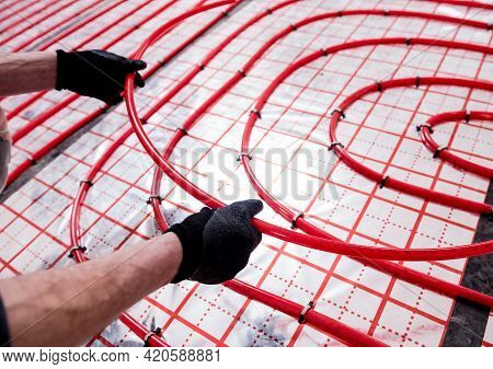 Pipefitter Install System Of Underfloor Heating System At Home