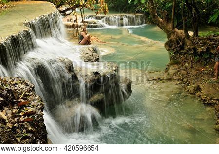 Laotian People And Foreign Travelers Travel Visit And Play Swimming Shallow Water Pool Atop Of Tat K