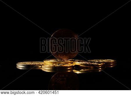 Dark Altcoin On Market. New Cryptocurrency On A Top Of Coins Against Black Mirror Surface. Black Cry