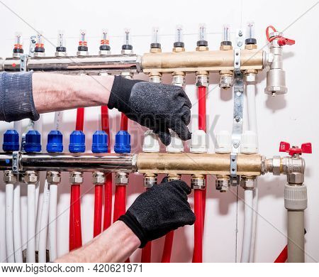 Pipefitter Install System Of Underfloor Heating System At Home