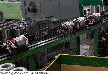 Electric Motors Manufacture In Industrial Company - Stators On Assembly Line Of Semi-automated Manua