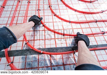 Pipefitter Install System Of Underfloor Heating System At Home