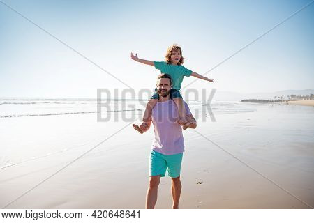 Little Boy Kid With Daddy Carrying Him On Shoulders. Dad And Child Walk Together. Family Travel, Vac