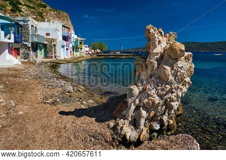 Scenic picturesque greek fishing village Klima with whitewashed traditional houses and colorful windows and doors on Milos island in Greece