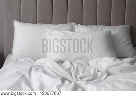 White Soft Pillows On Comfortable Bed Indoors