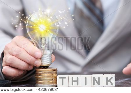 Businessman Hand Light Bulb On Cions ,idea Innovation And Inspiration Concept, New Ideas In The Futu