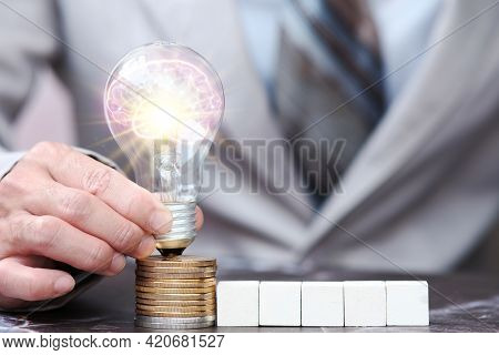Businessman Hand Light Bulb On Cions ,idea Innovation And Inspiration Concept, New Ideas In The Futu