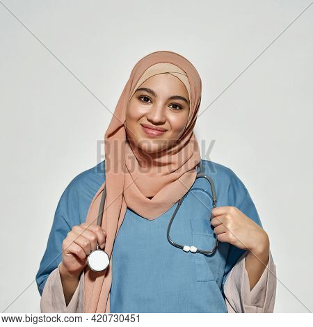 Portrait Of Smiling Young Arabian Woman In Doctor Outfit With Stethoscope Looking At Camera While Po