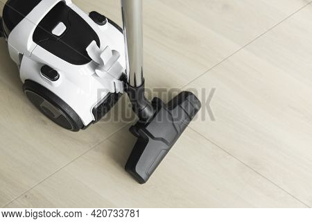 Bagless Cyclone Vacuum Cleaner On A Laminate. Electrical Apparatus That By Means Of Suction Collects