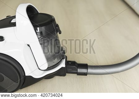 Bagless Cyclone Vacuum Cleaner On A Laminate. Electrical Apparatus That By Means Of Suction Collects
