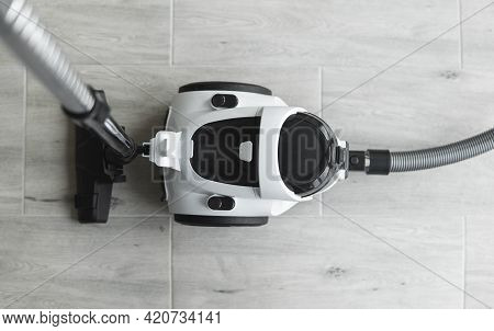 Bagless Cyclone Vacuum Cleaner On A Grey Tile. Electrical Apparatus That By Means Of Suction Collect