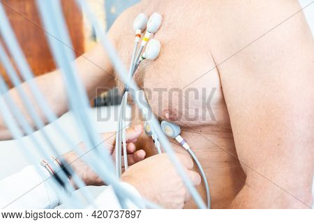 Doctor placing electrodes on patient for ecg