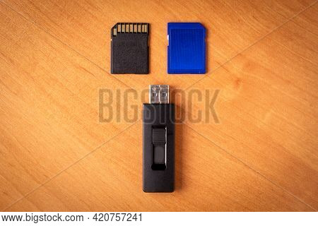 Flash Drive. Memory Card.wood Background.memory Drives On The Table