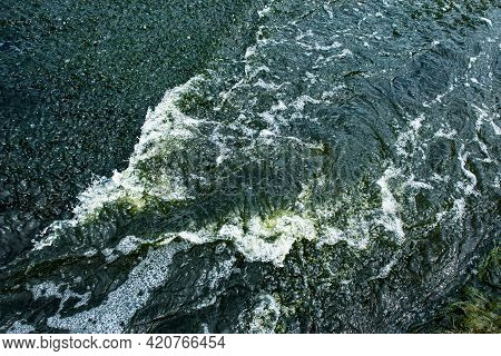 The Texture Of Water On The Surface Of A Small Waterfall In The Ukrainian Steppe Close-up. Tokovsky