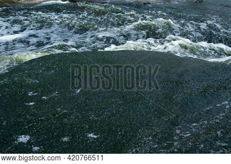 The Texture Of Water On The Surface Of A Small Waterfall In The Ukrainian Steppe Close-up. Tokovsky