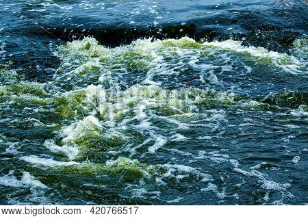 The Texture Of Water On The Surface Of A Small Waterfall In The Ukrainian Steppe Close-up. Tokovsky