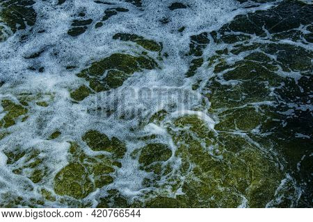 The Texture Of Water On The Surface Of A Small Waterfall In The Ukrainian Steppe Close-up. Tokovsky