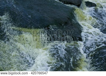 The Texture Of Water On The Surface Of A Small Waterfall In The Ukrainian Steppe Close-up. Tokovsky