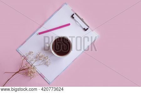Cup Of Coffee. Flower Of Gypsophila, Notepad On Colored Background